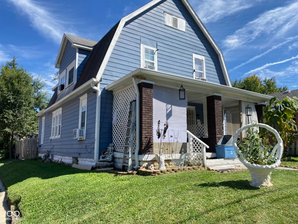 view of front of home with a front lawn and cooling unit