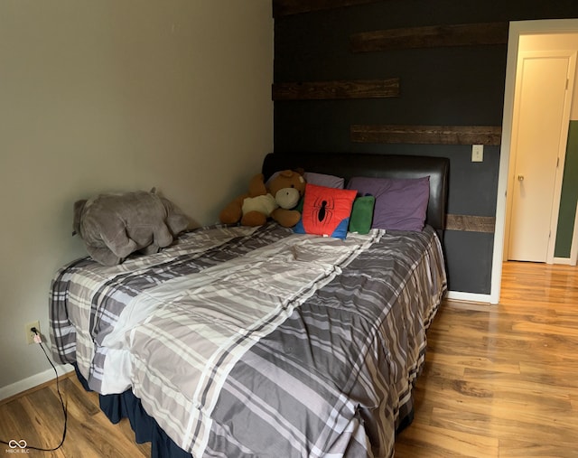 bedroom with hardwood / wood-style floors