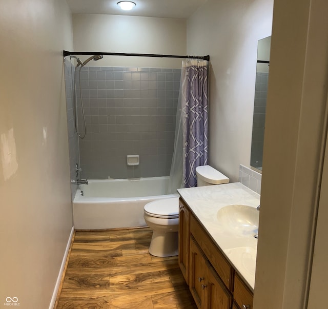 full bathroom with shower / bath combo with shower curtain, hardwood / wood-style flooring, vanity, and toilet