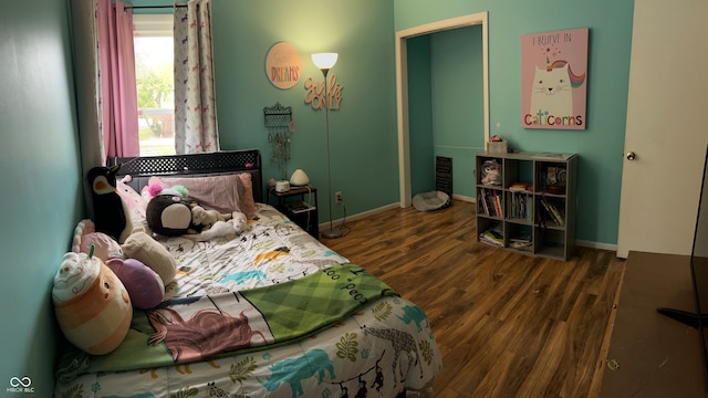 bedroom with dark hardwood / wood-style floors