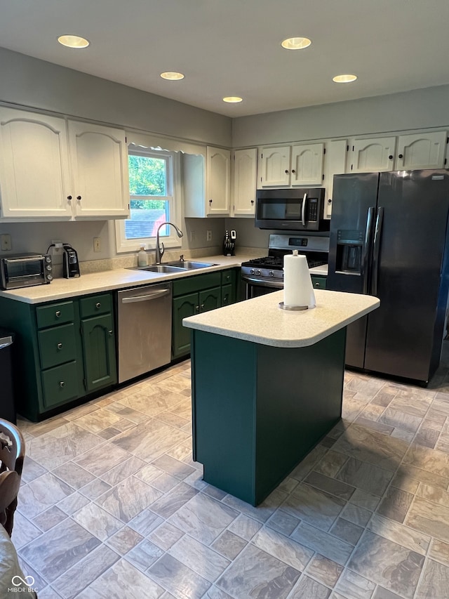 kitchen with stainless steel appliances, sink, and white cabinetry