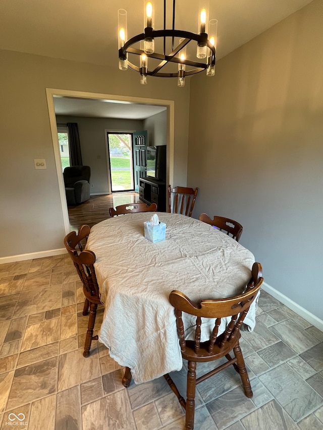 dining area with an inviting chandelier