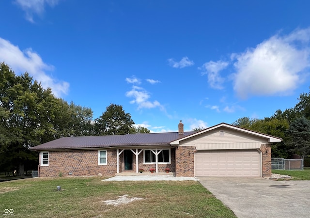 ranch-style home with a front yard and a garage