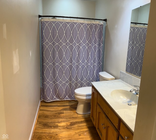 bathroom with a shower with curtain, vanity, toilet, and hardwood / wood-style flooring