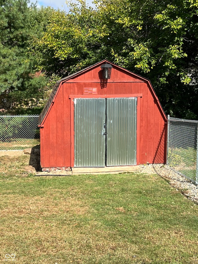 view of outbuilding featuring a yard