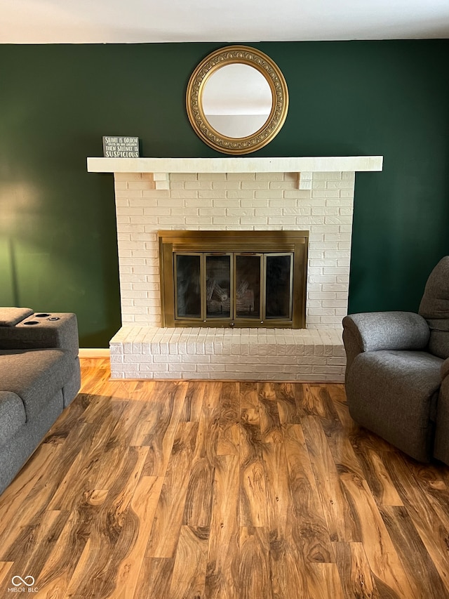 interior space featuring a brick fireplace and hardwood / wood-style floors