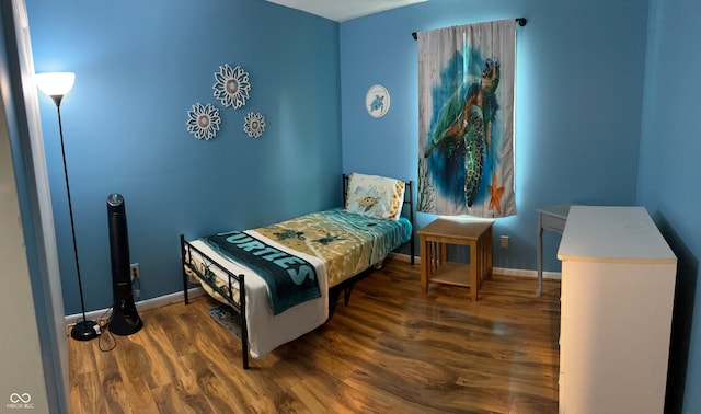 bedroom with dark wood-type flooring