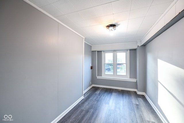 unfurnished room with dark hardwood / wood-style floors and crown molding