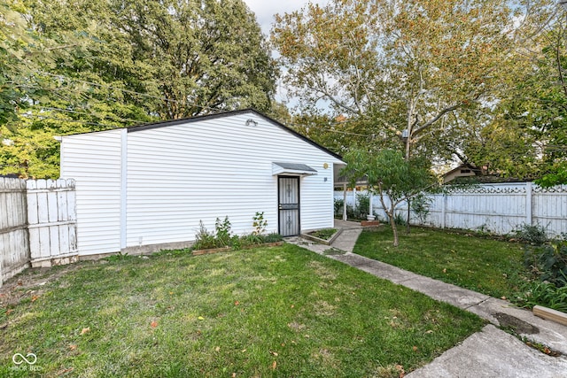 view of outbuilding with a lawn