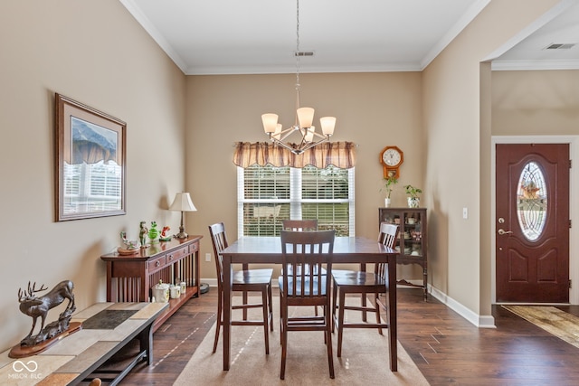 dining area with crown molding, dark hardwood / wood-style floors, and an inviting chandelier