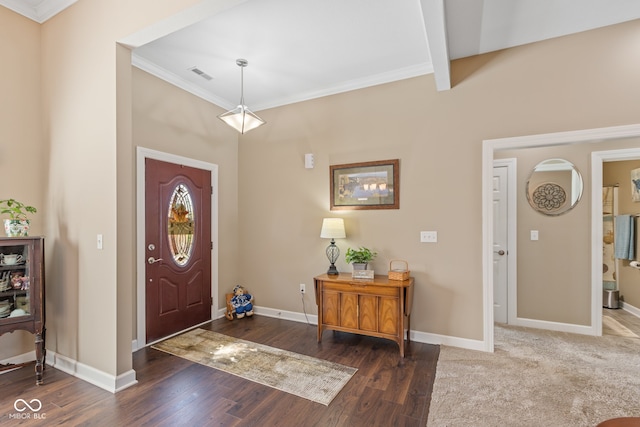 foyer with dark wood-type flooring, crown molding, and beamed ceiling