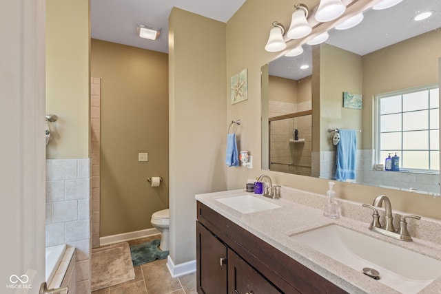 full bathroom featuring vanity, toilet, tile patterned floors, and independent shower and bath