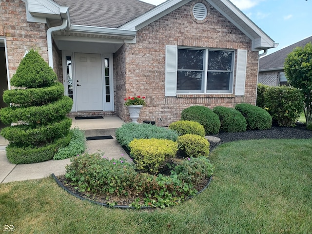 doorway to property featuring a yard