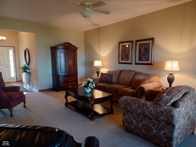 carpeted living room featuring ceiling fan