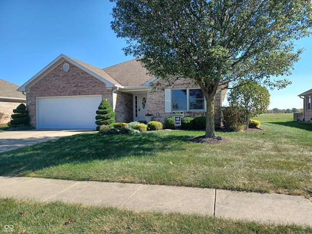 view of front of property with a front yard and a garage