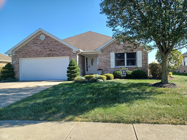 ranch-style home with a garage and a front lawn