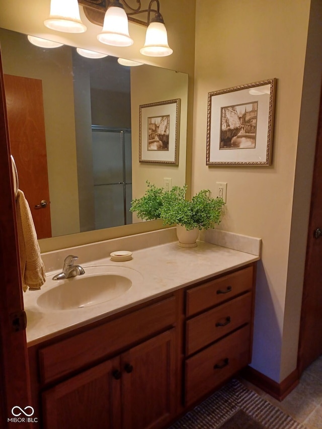 bathroom featuring vanity, tile patterned floors, and walk in shower