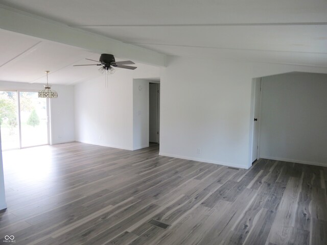 unfurnished room with dark wood-type flooring, vaulted ceiling with beams, and ceiling fan