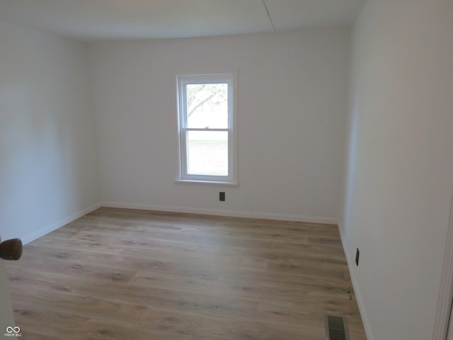 spare room featuring light hardwood / wood-style flooring