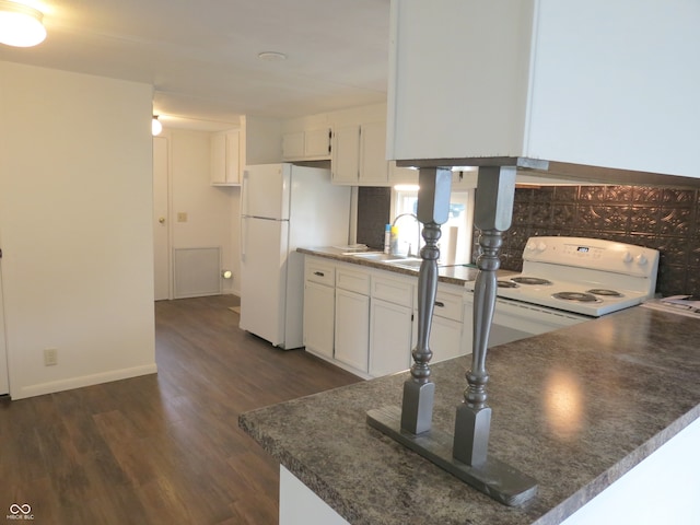 kitchen featuring kitchen peninsula, white cabinets, dark hardwood / wood-style flooring, sink, and white appliances