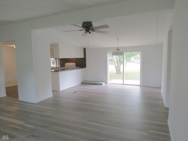 unfurnished living room with ceiling fan and hardwood / wood-style floors