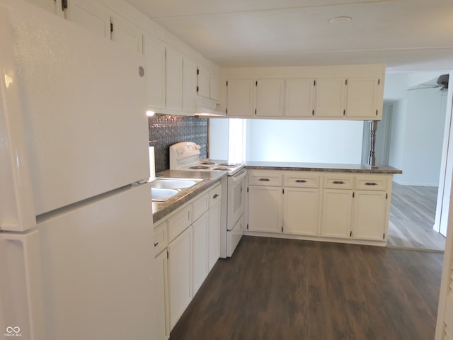 kitchen with kitchen peninsula, decorative backsplash, white cabinetry, dark hardwood / wood-style floors, and white appliances