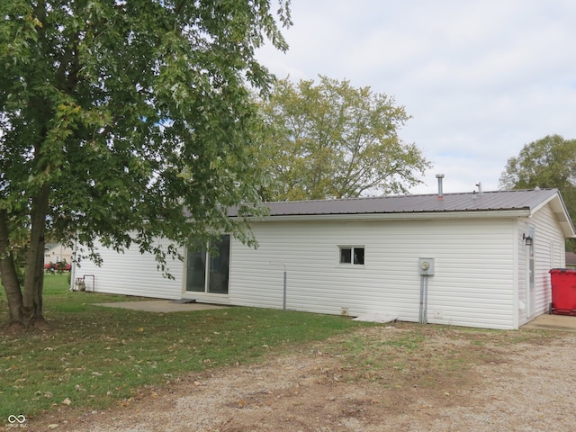 rear view of house with a yard