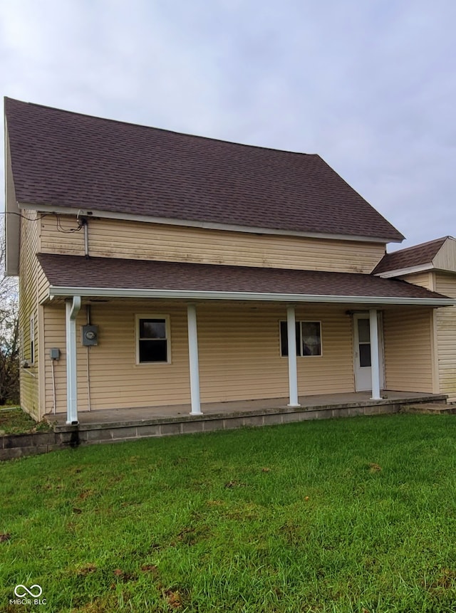 back of property featuring a yard