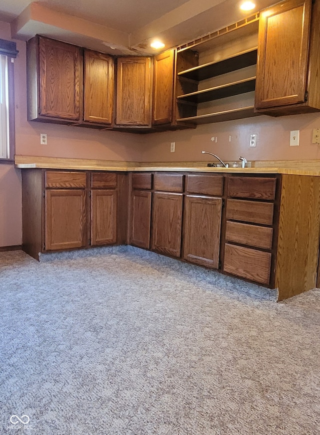 kitchen featuring light carpet