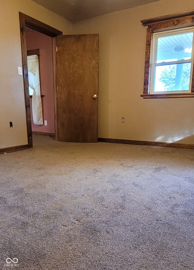 unfurnished room with carpet flooring