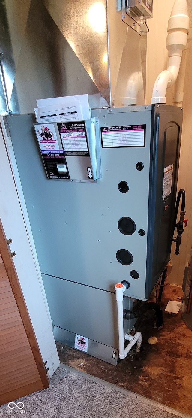 utility room featuring heating unit