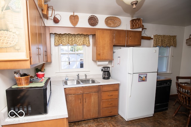 kitchen with white fridge, dishwasher, and sink