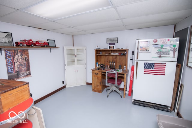 office space with a drop ceiling and concrete floors