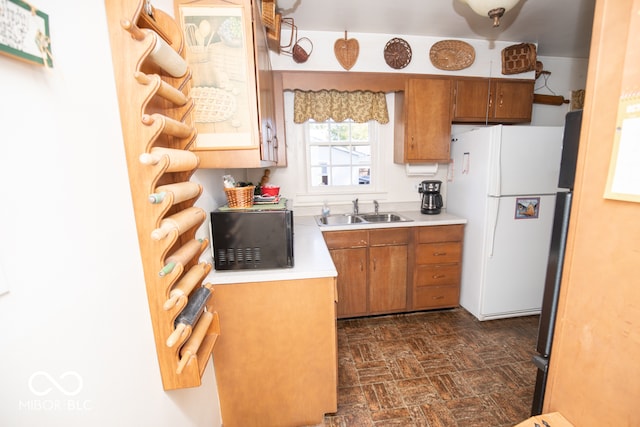 kitchen featuring sink and white refrigerator