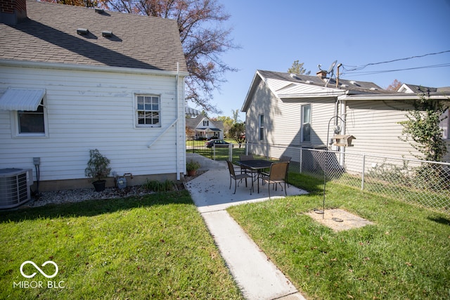 view of yard featuring central AC and a patio area