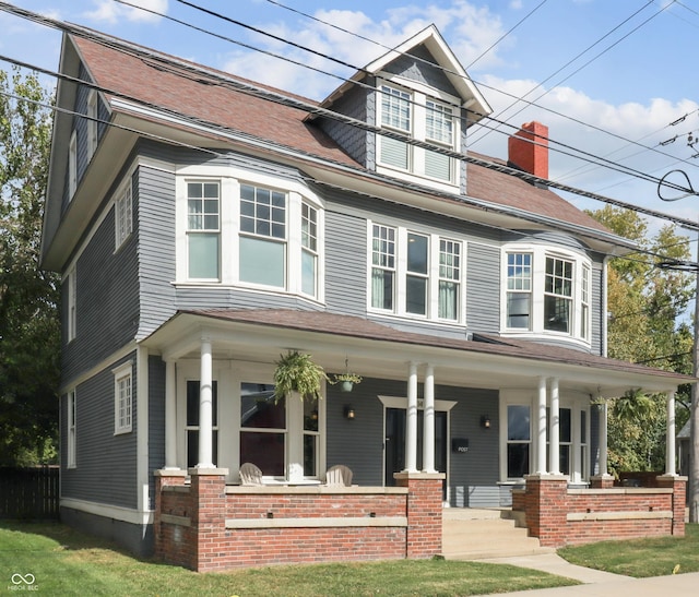 view of front of house with a porch and fence