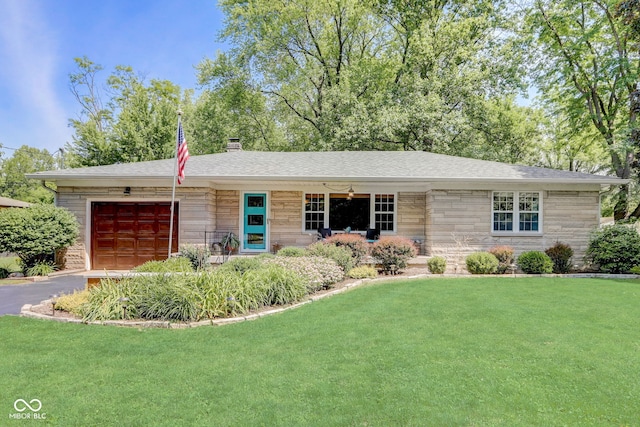 ranch-style house featuring a front yard and a garage