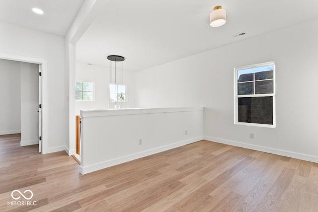 unfurnished room with light wood-type flooring