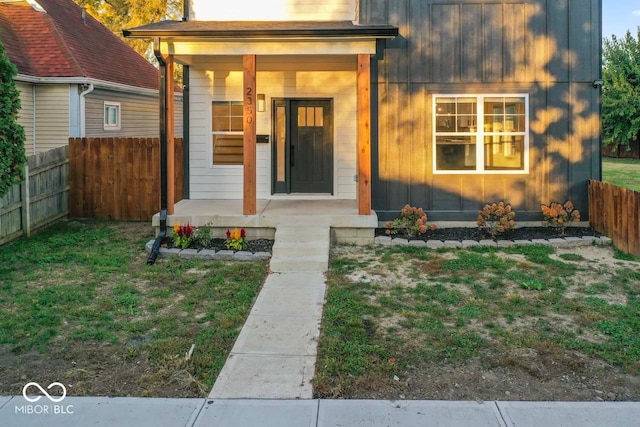 view of front of house with a front yard and a porch