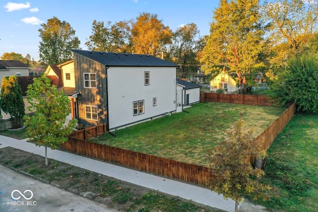 view of side of home with a yard