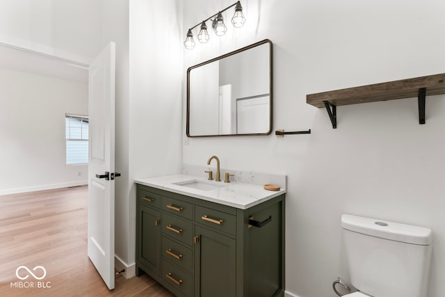 bathroom featuring vanity, toilet, and hardwood / wood-style floors