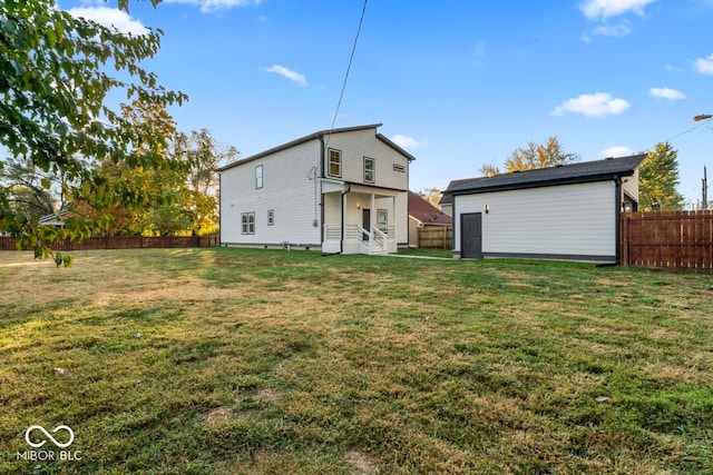 rear view of house featuring a lawn