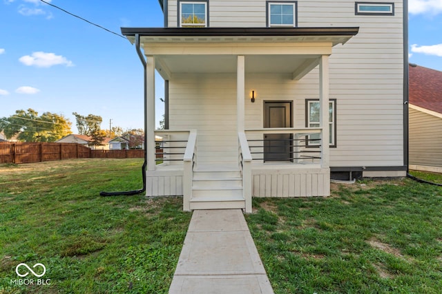 exterior space with covered porch and a lawn