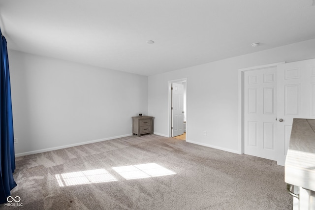 unfurnished room with light colored carpet