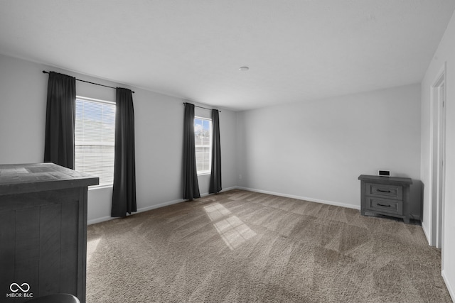 carpeted spare room with plenty of natural light