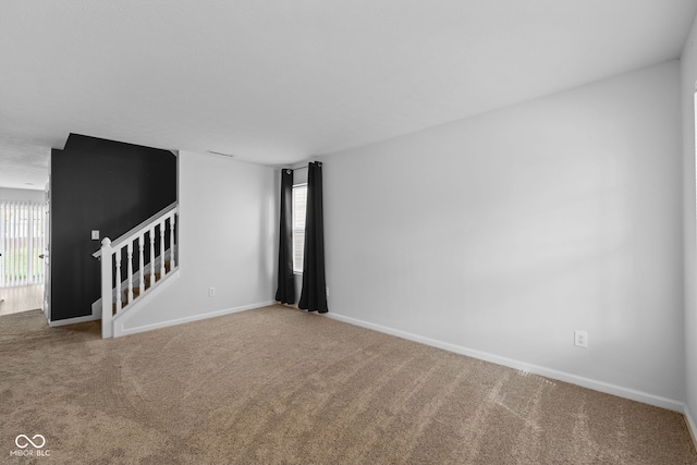 unfurnished room featuring carpet