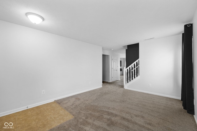 unfurnished room featuring carpet