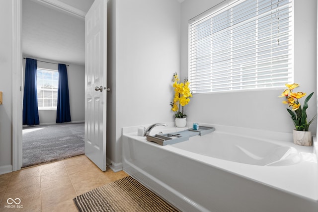 bathroom featuring a bath and tile patterned flooring