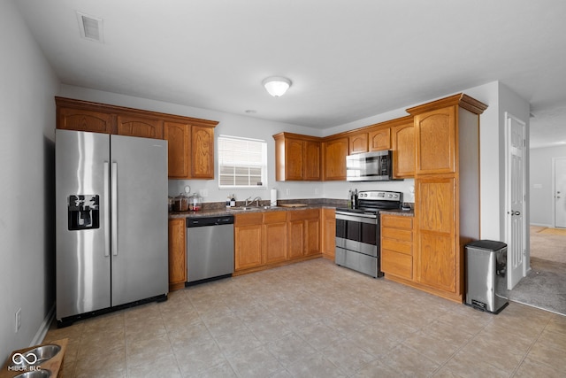 kitchen with sink and appliances with stainless steel finishes