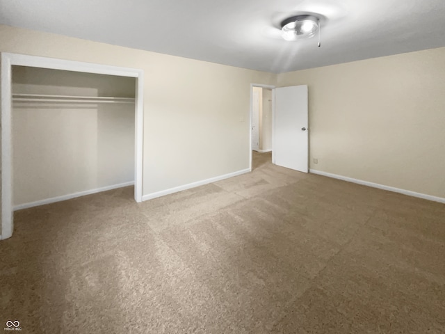 unfurnished bedroom featuring carpet floors and a closet